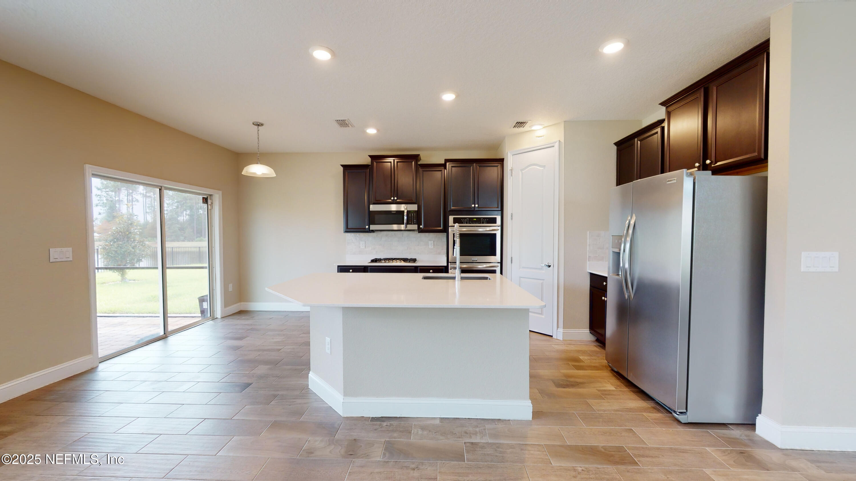 201 Silver Creek Place St. Augustine, FL 32095 - Photo 6 of 26 a kitchen with stainless steel appliances a refrigerator and a stove top oven