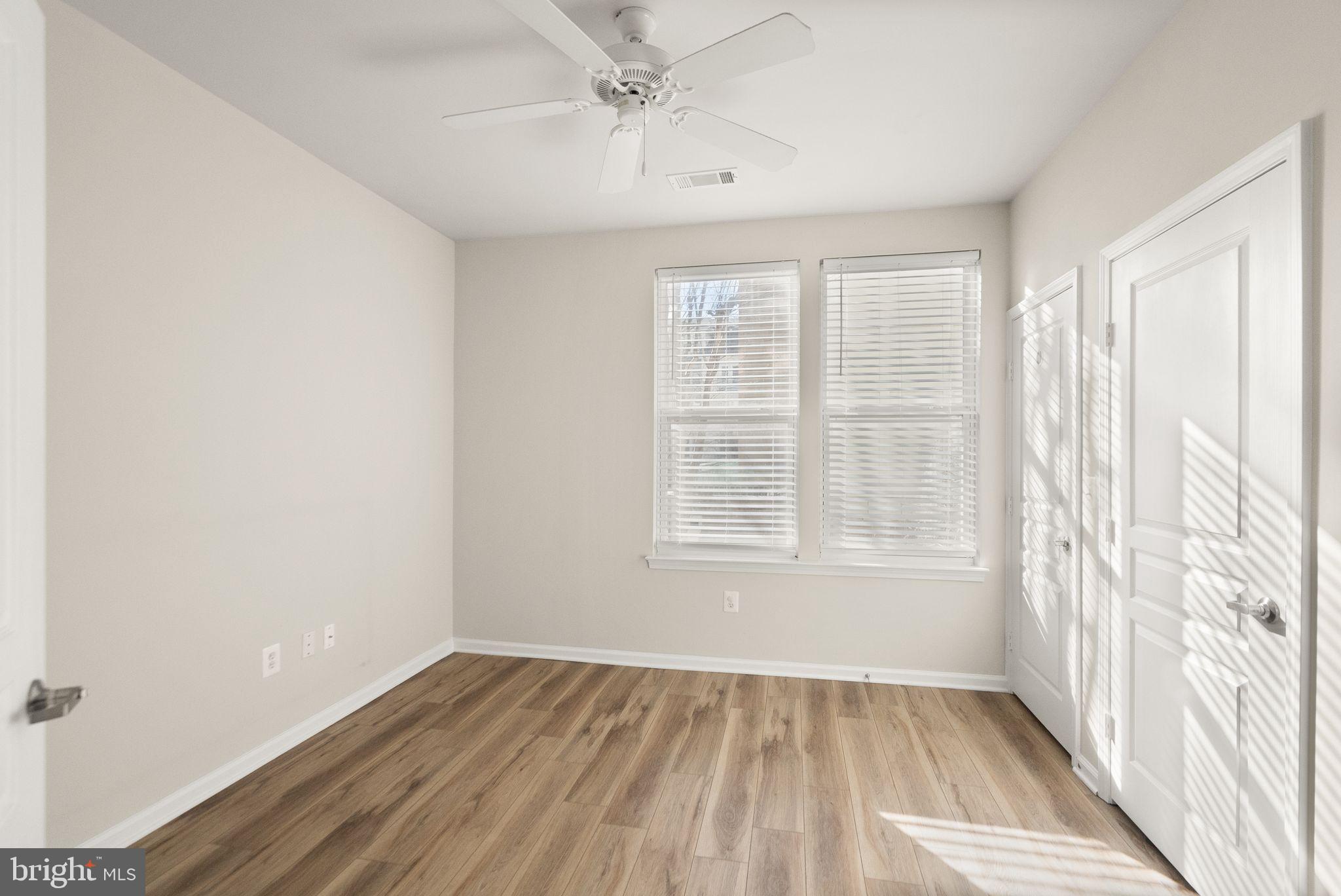 12001 Market Street, Unit 206 Reston, VA 20190 - Photo 15 of 25 wooden floor in an empty room with a window