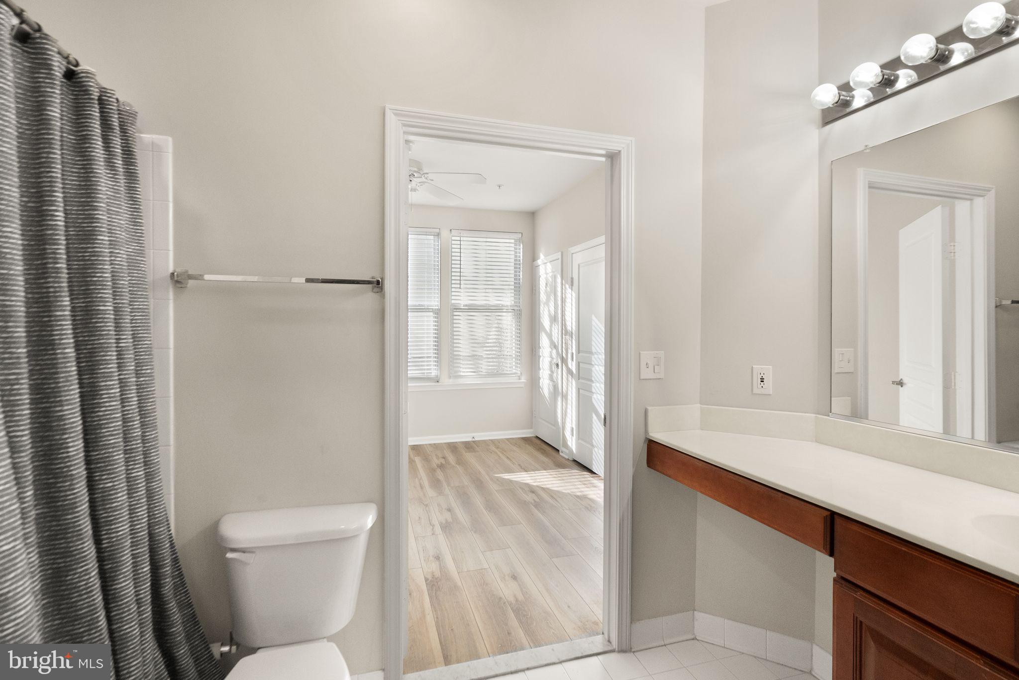 12001 Market Street, Unit 206 Reston, VA 20190 - Photo 20 of 25 a bathroom with a sink a toilet and shower