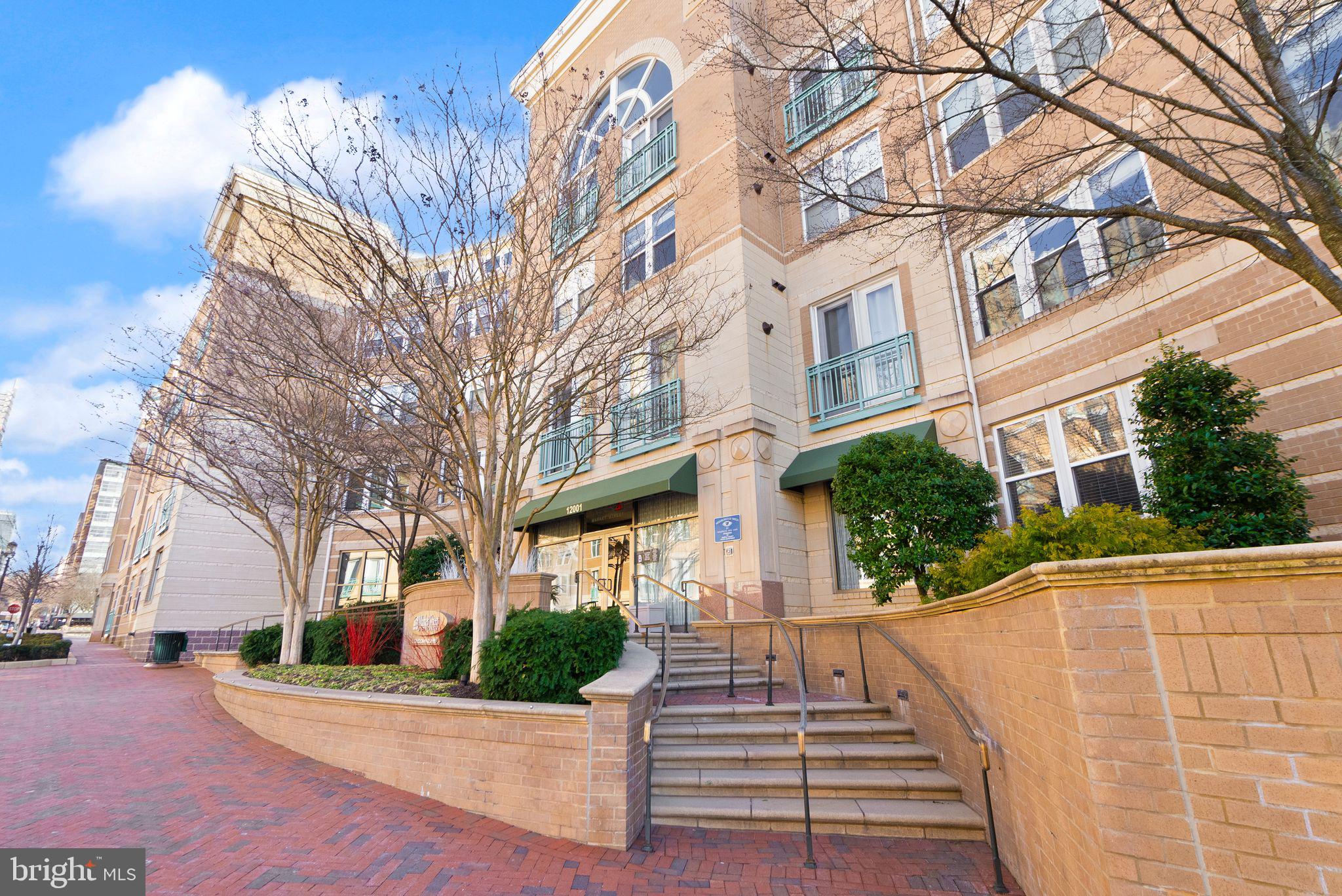 12001 Market Street, Unit 206 Reston, VA 20190 - Photo 2 of 25 a view of a white building among the street