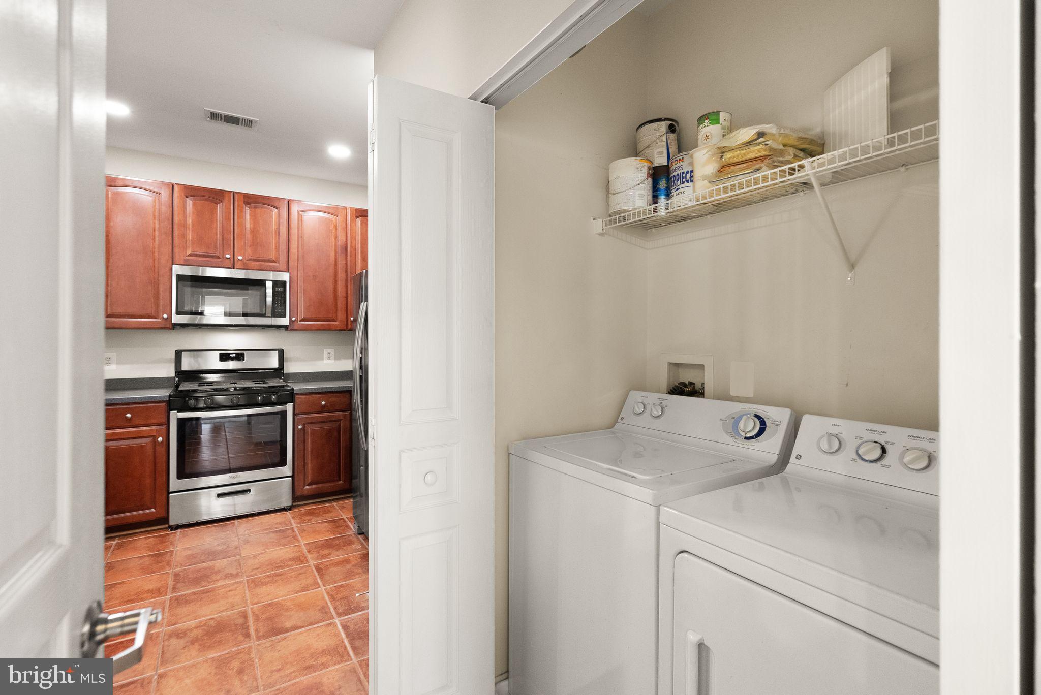 12001 Market Street, Unit 206 Reston, VA 20190 - Photo 23 of 25 a kitchen with a stove and a microwave