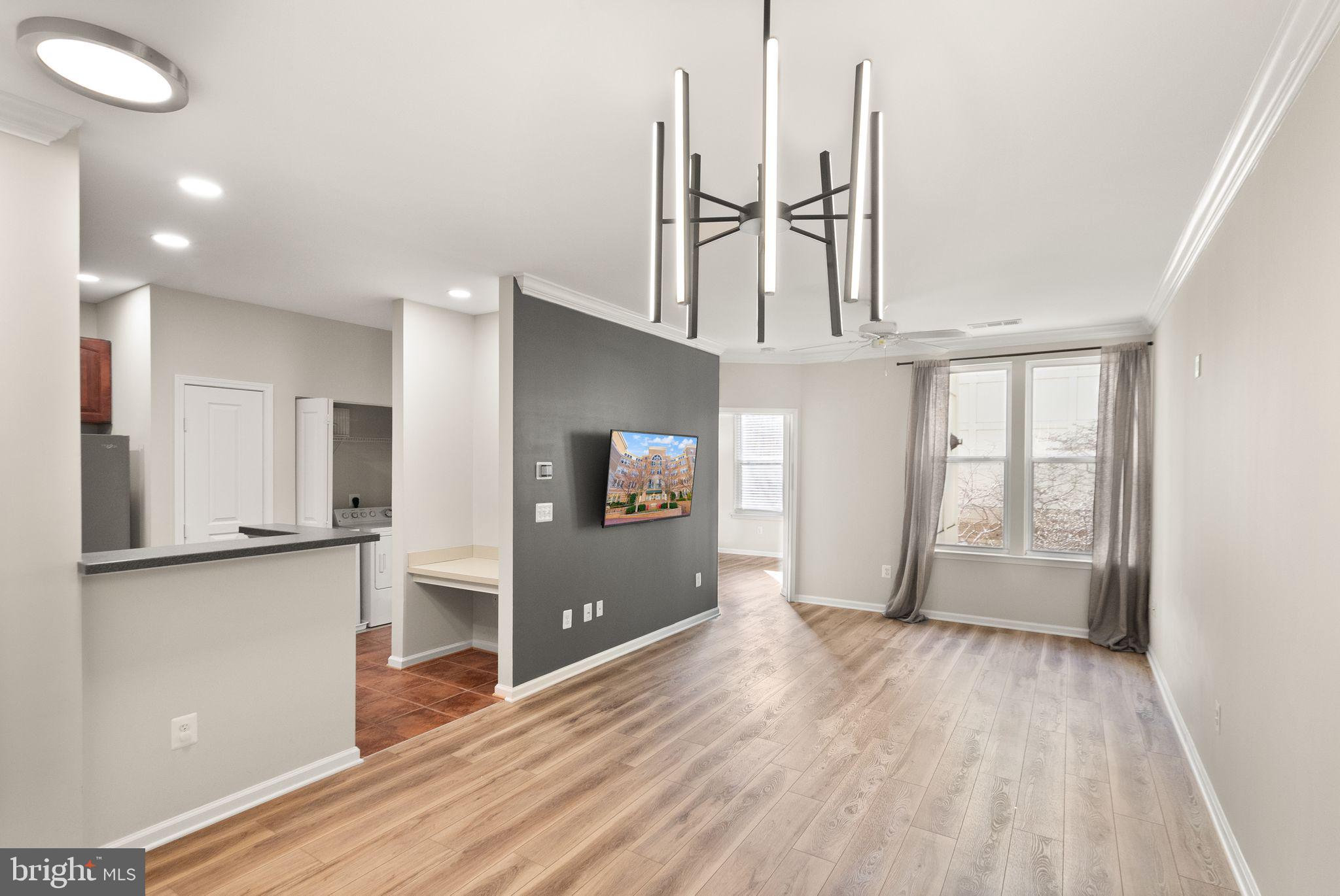 12001 Market Street, Unit 206 Reston, VA 20190 - Photo 5 of 25 a view of empty room with wooden floor