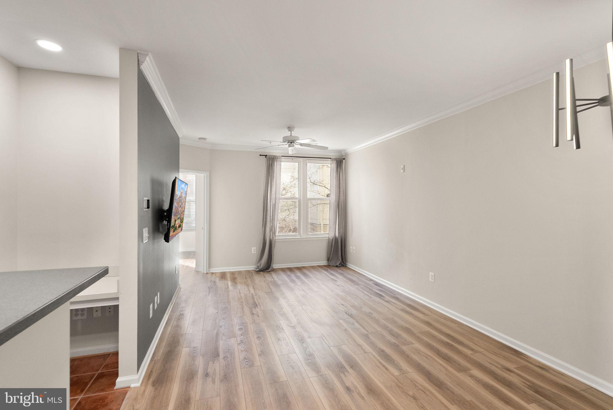 12001 Market Street, Unit 206 Reston, VA 20190 - Photo 6 of 25 wooden floor in an empty room with a window