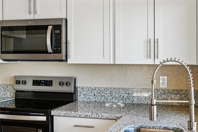 a kitchen with a stove and a microwave