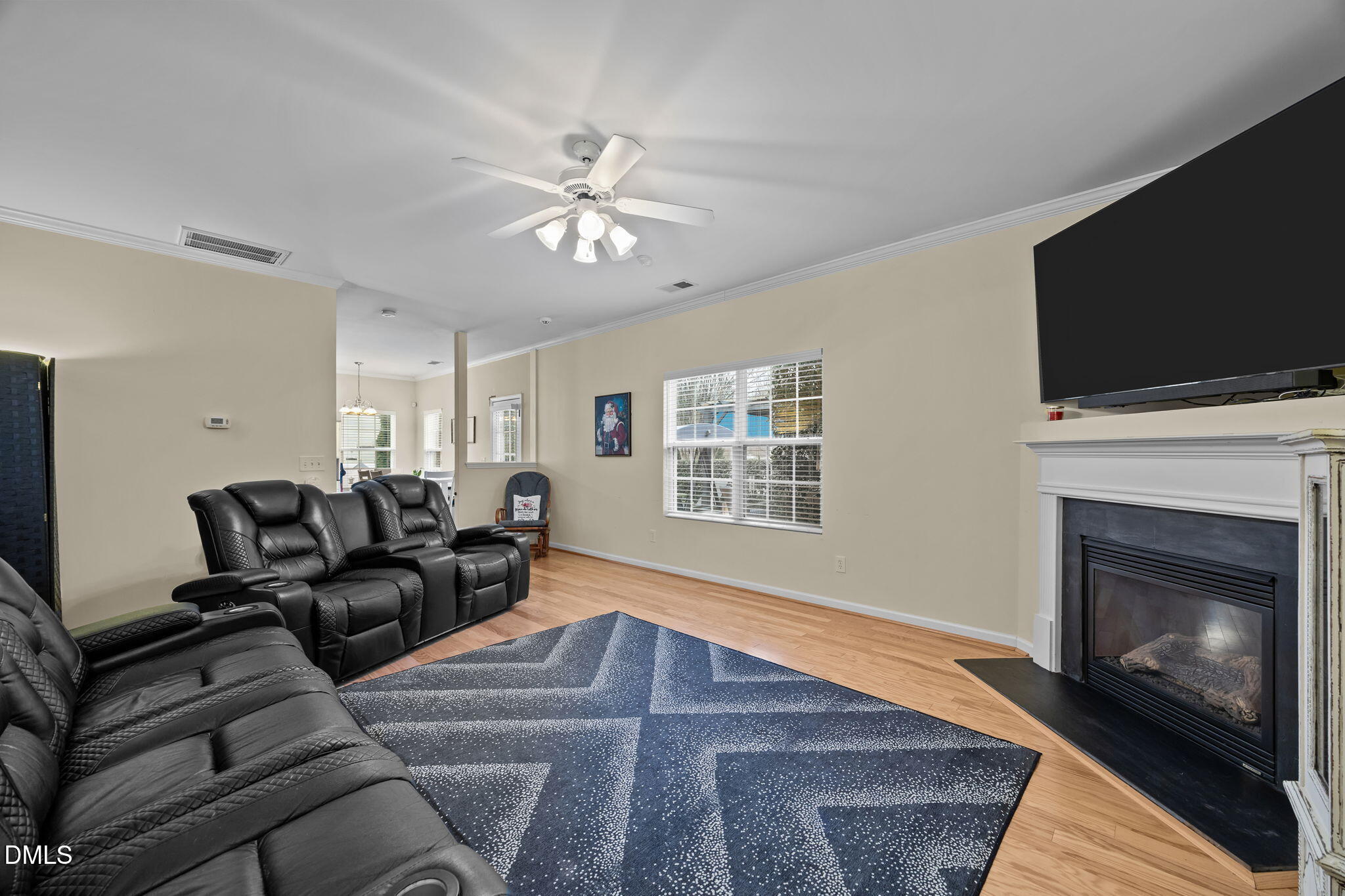1511 Brambleton Court Graham, NC 27253 - Photo 15 of 43 a living room with furniture a fireplace and a flat screen tv