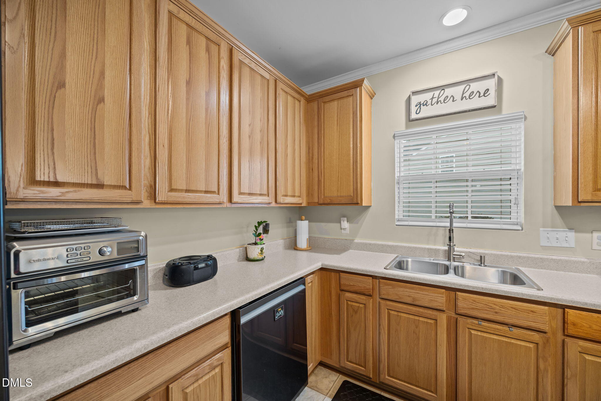 1511 Brambleton Court Graham, NC 27253 - Photo 8 of 43 a kitchen with stainless steel appliances wooden cabinets a sink and a window