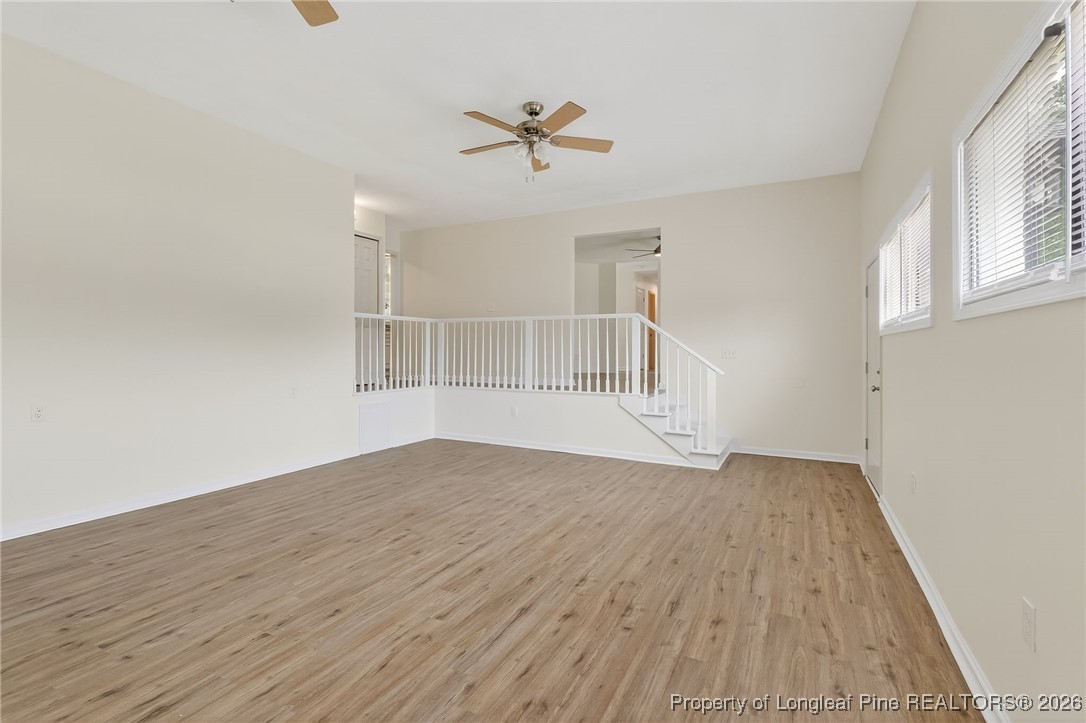 6250 Waldos Beach Road Fayetteville, NC 28306 - Photo 14 of 50 a view of a livingroom with wooden floor and a ceiling fan