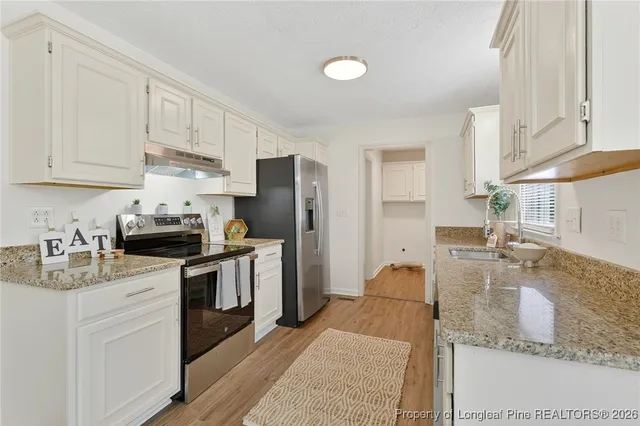 a kitchen with a sink stove and refrigerator