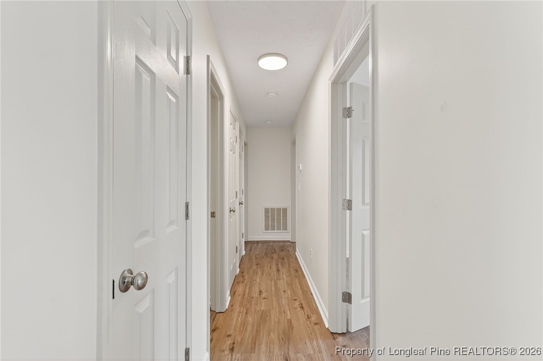 6250 Waldos Beach Road Fayetteville, NC 28306 - Photo 30 of 50 a view of a hallway with wooden floor and staircase