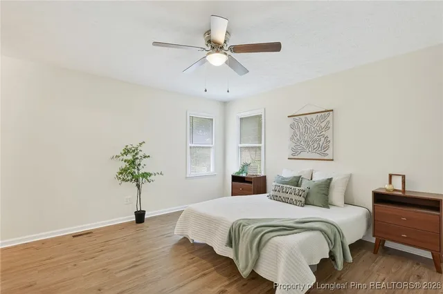 a bedroom with a bed and a potted plant