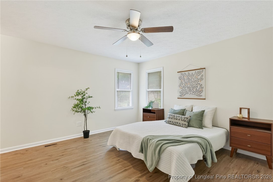 6250 Waldos Beach Road Fayetteville, NC 28306 - Photo 36 of 50 a bedroom with a bed and a potted plant