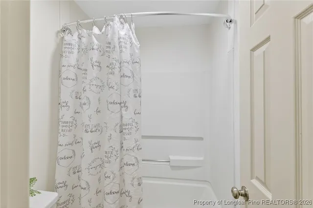 a bathroom with a shower curtain and a toilet