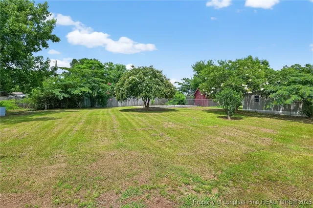 a house view with swimming pool and garden