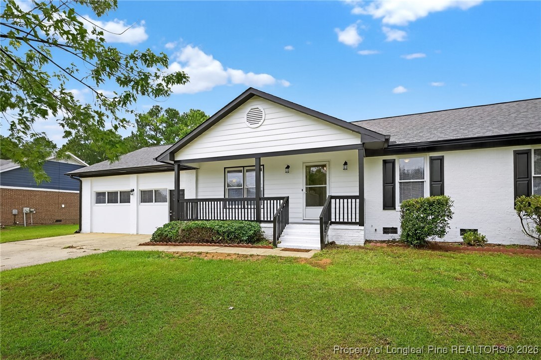 6250 Waldos Beach Road Fayetteville, NC 28306 - Photo 4 of 50 a front view of a house with a garden and porch