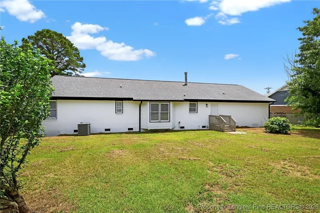a large white house with a large pool