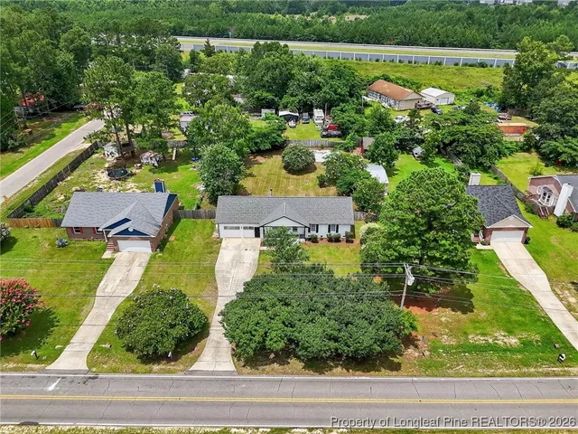 an aerial view of a house with a yard and lake view