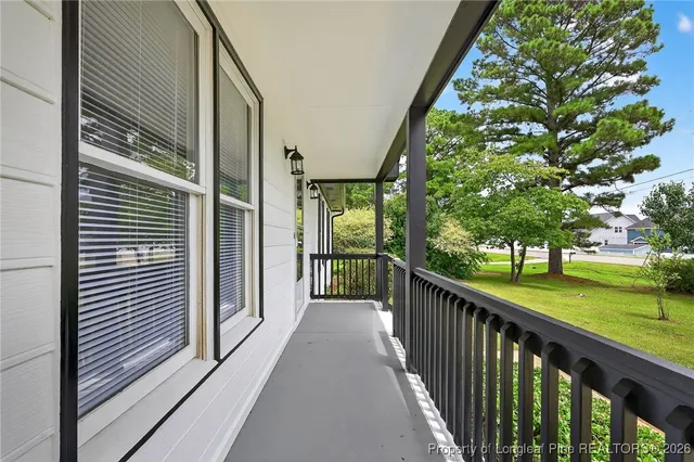 a view of a porch with wooden floor and fence