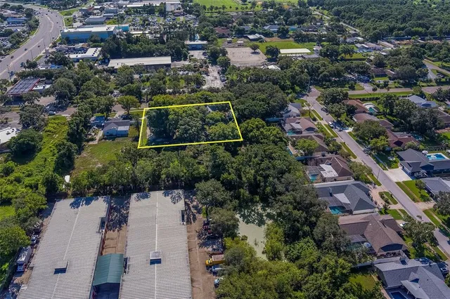 an aerial view of residential houses with outdoor space and swimming pool