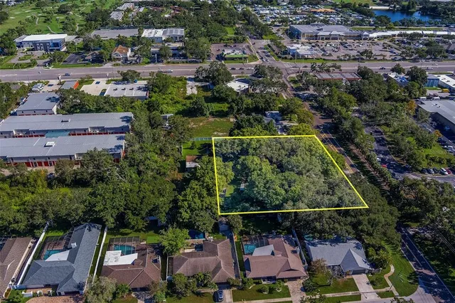 an aerial view of house with tennis court