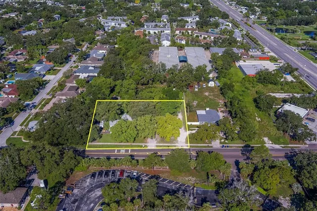 an aerial view of residential houses with outdoor space and street view