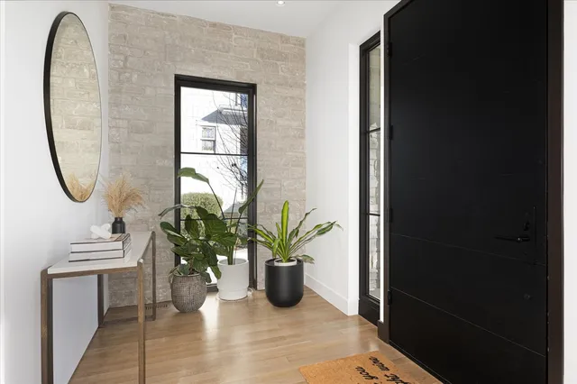 a living room with furniture potted plant and a chandelier