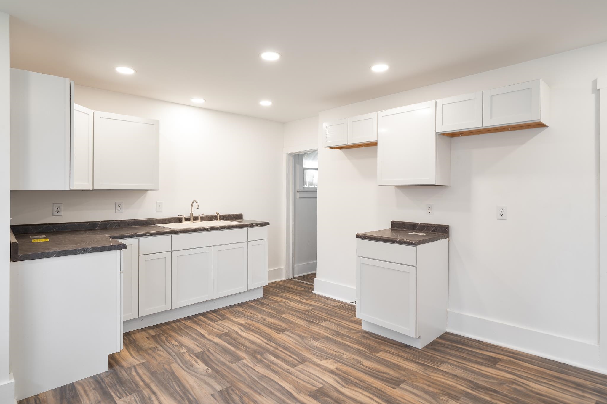 506 South 4th Street Oregon, IL 61061 - Photo 13 of 45 a kitchen with granite countertop white cabinets and white appliances