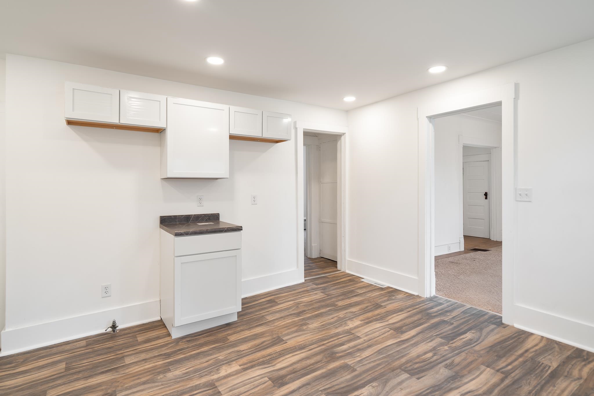 506 South 4th Street Oregon, IL 61061 - Photo 15 of 45 a kitchen with a refrigerator and white cabinets