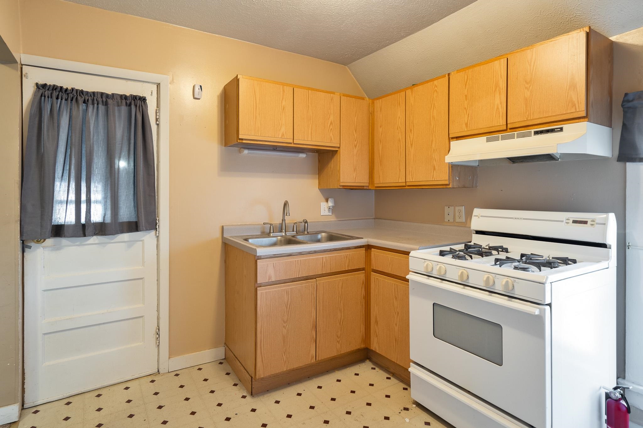 506 South 4th Street Oregon, IL 61061 - Photo 33 of 45 a kitchen with a stove top oven sink and cabinets