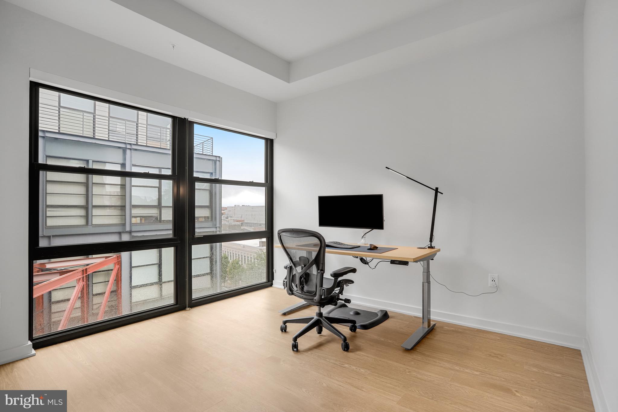 1625 Eckington Place Northeast, Unit 604 Washington, DC 20002 - Photo 25 of 68 a view of a workspace with furniture and a window