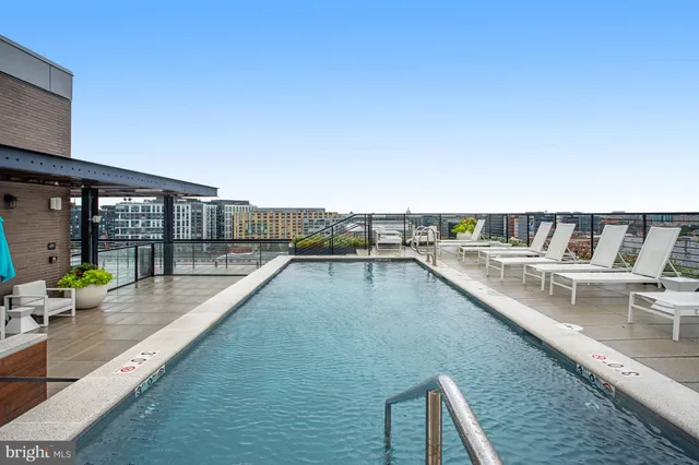 a dining room with furniture and large windows