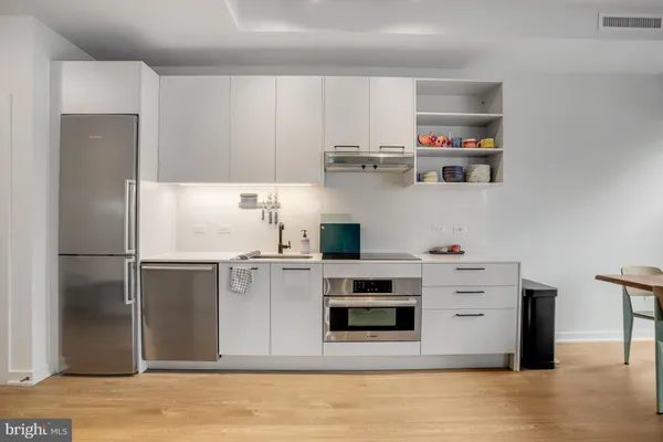 a dining room with furniture and a large window