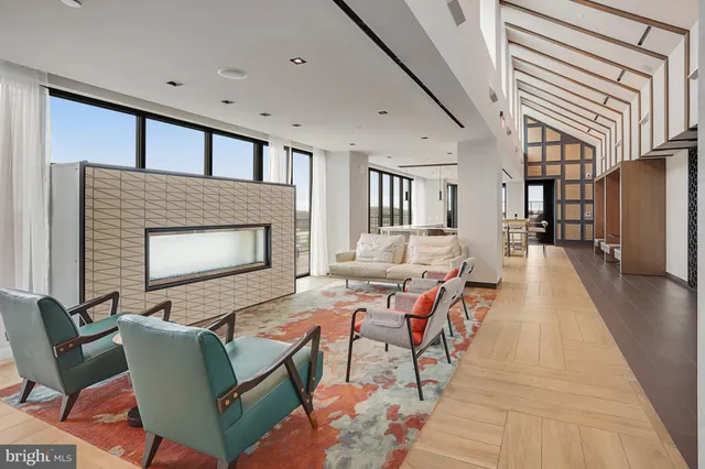 a view of a hallway with wooden floor and windows