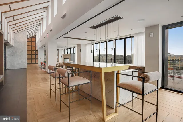 a view of a building with a cars park side of a road