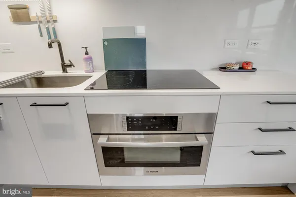 a bed room with a bed and a kitchen