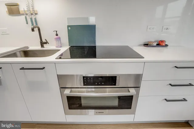 a bed room with a bed and a kitchen