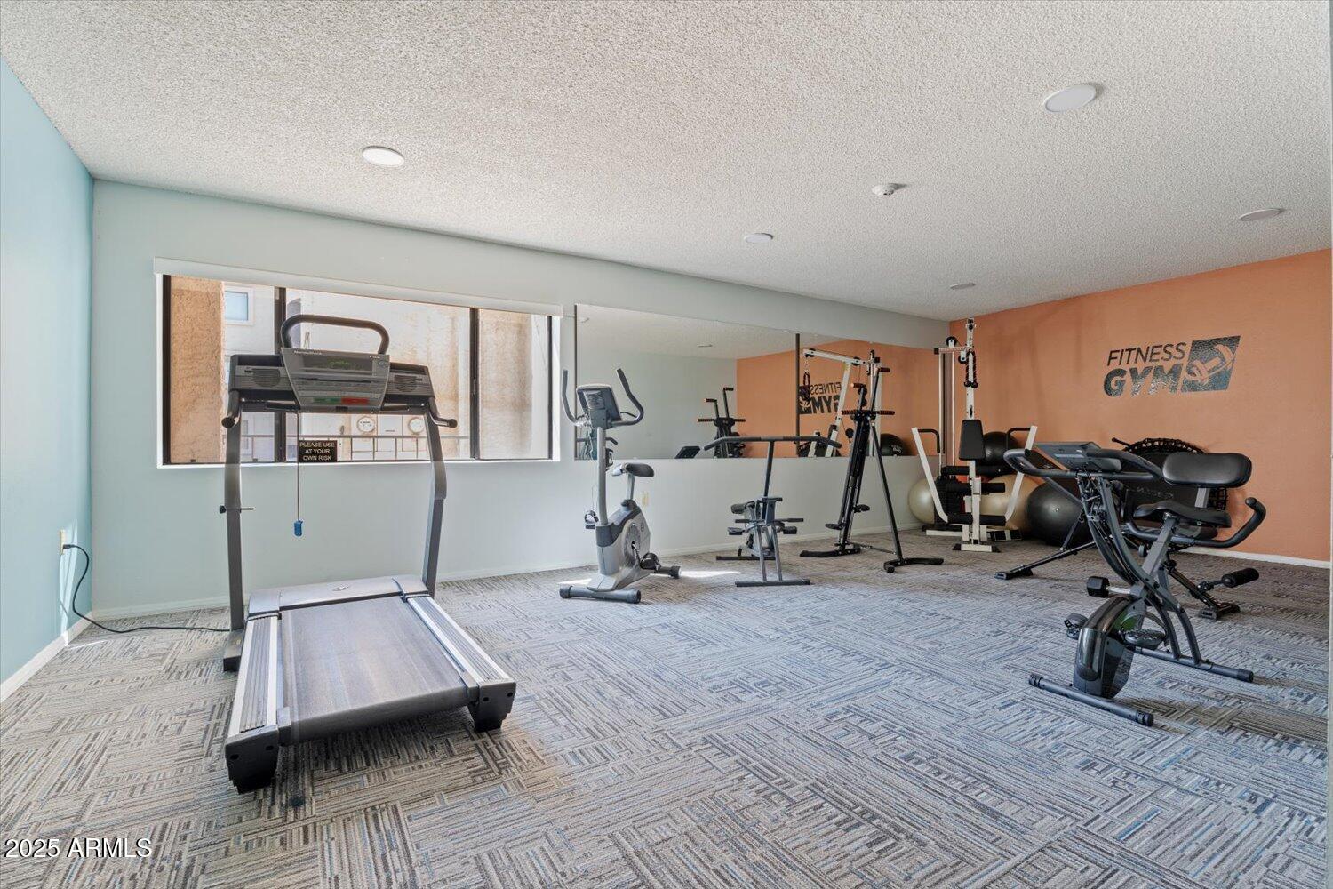 3033 East Devonshire Avenue, Unit 2003 Phoenix, AZ 85016 - Photo 18 of 32 a room with gym equipment and a table