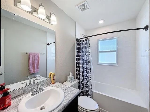 a bathroom with a sink toilet tub and shower