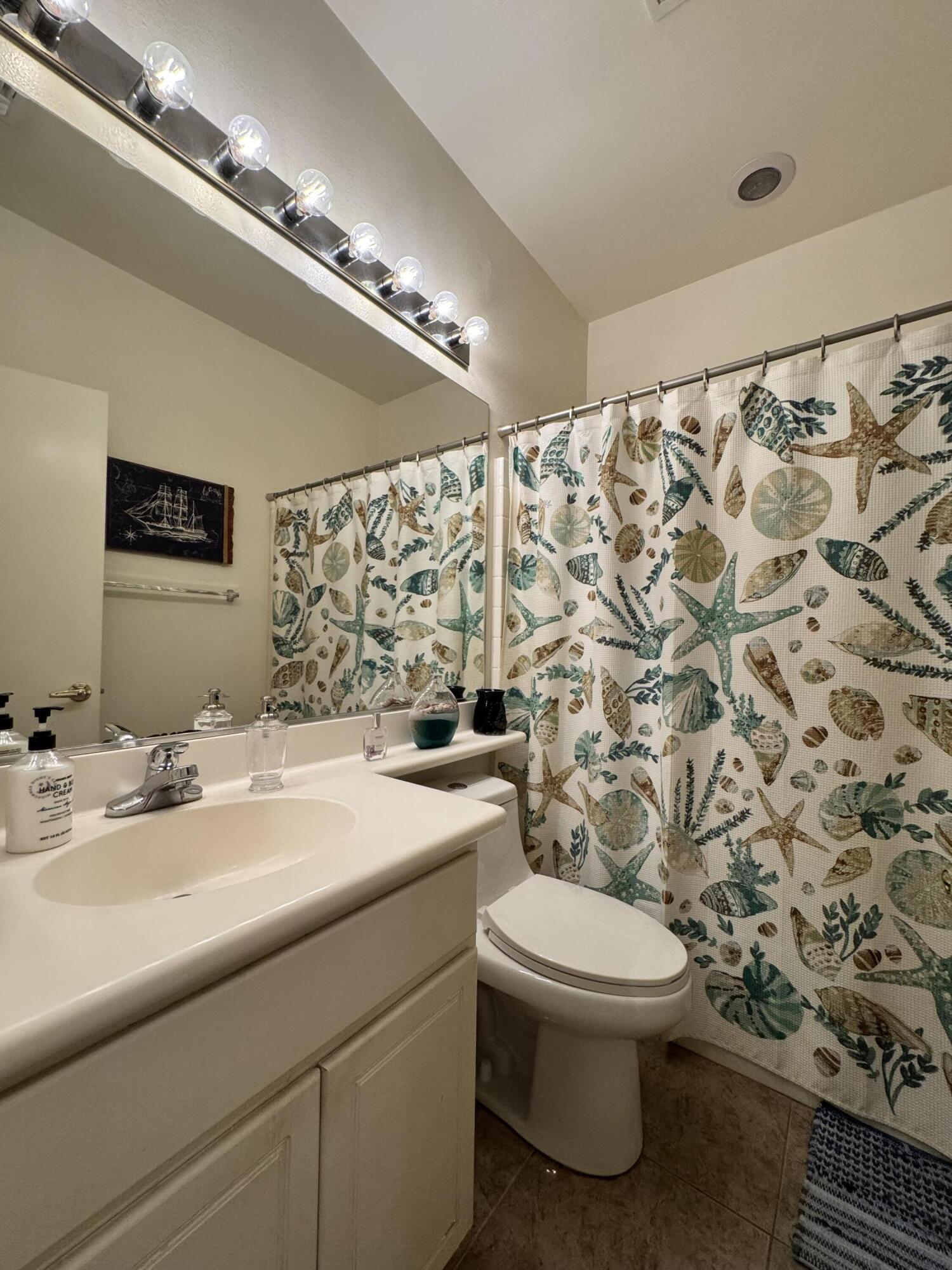 82774 Matthau Drive Indio, CA 92201 - Photo 23 of 44 a bathroom with a sink a toilet and a mirror