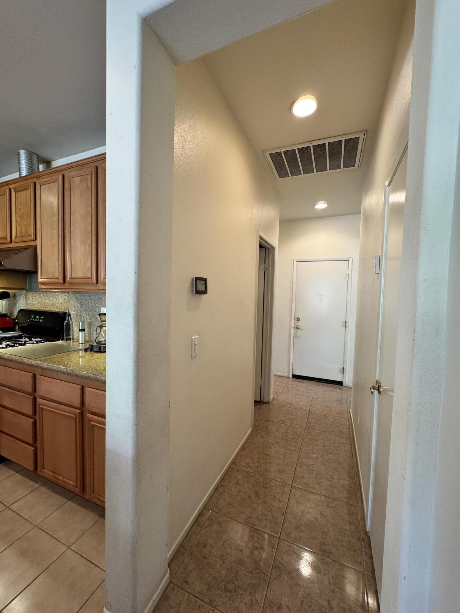 82774 Matthau Drive Indio, CA 92201 - Photo 24 of 44 a view of a hallway to rooms and wooden floor