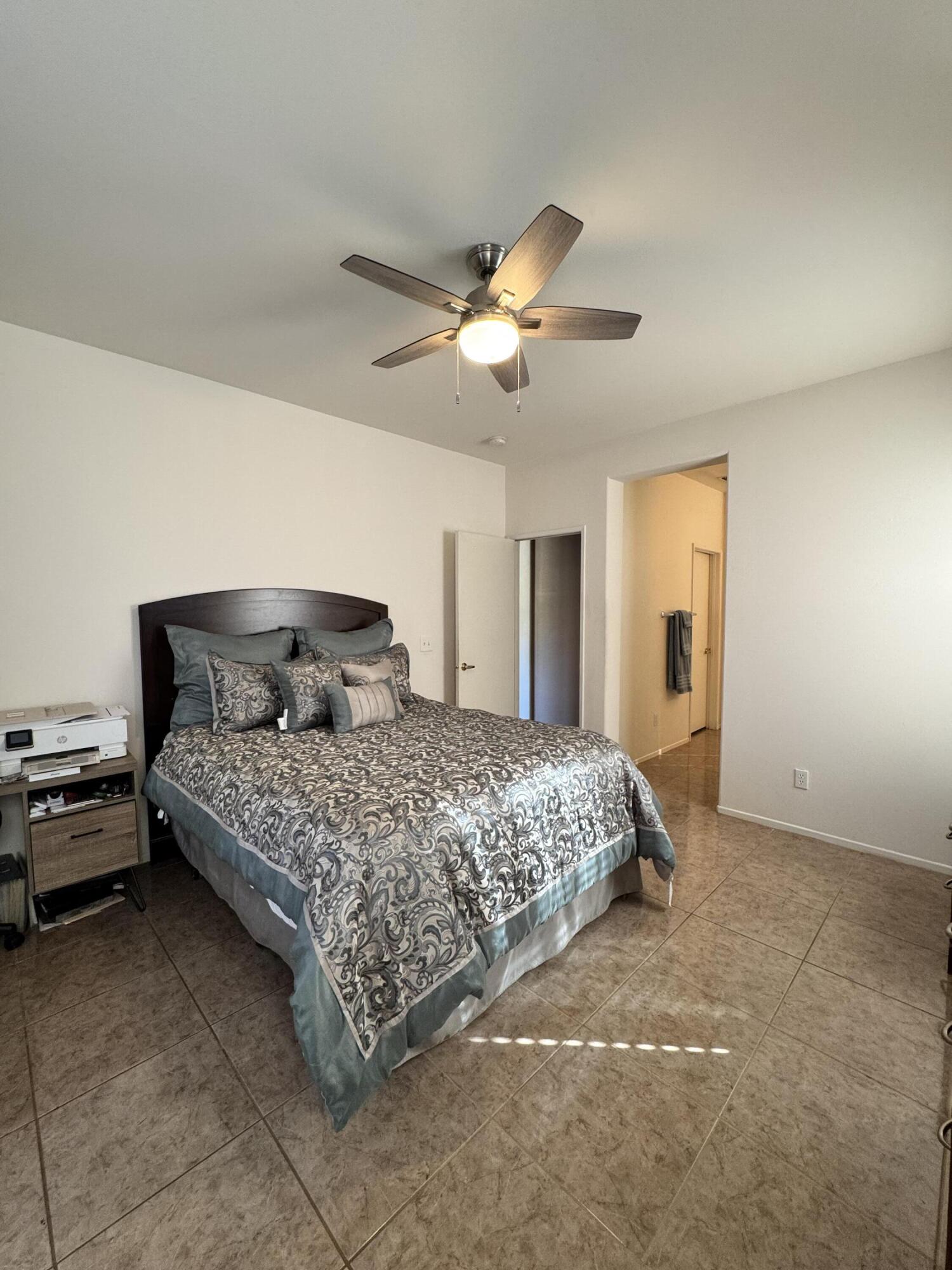 82774 Matthau Drive Indio, CA 92201 - Photo 28 of 44 a bedroom with a bed and a ceiling fan