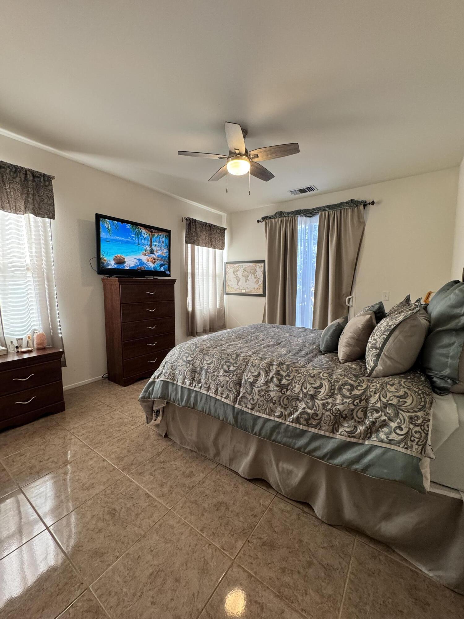 82774 Matthau Drive Indio, CA 92201 - Photo 29 of 44 a bedroom with a bed and a flat screen tv