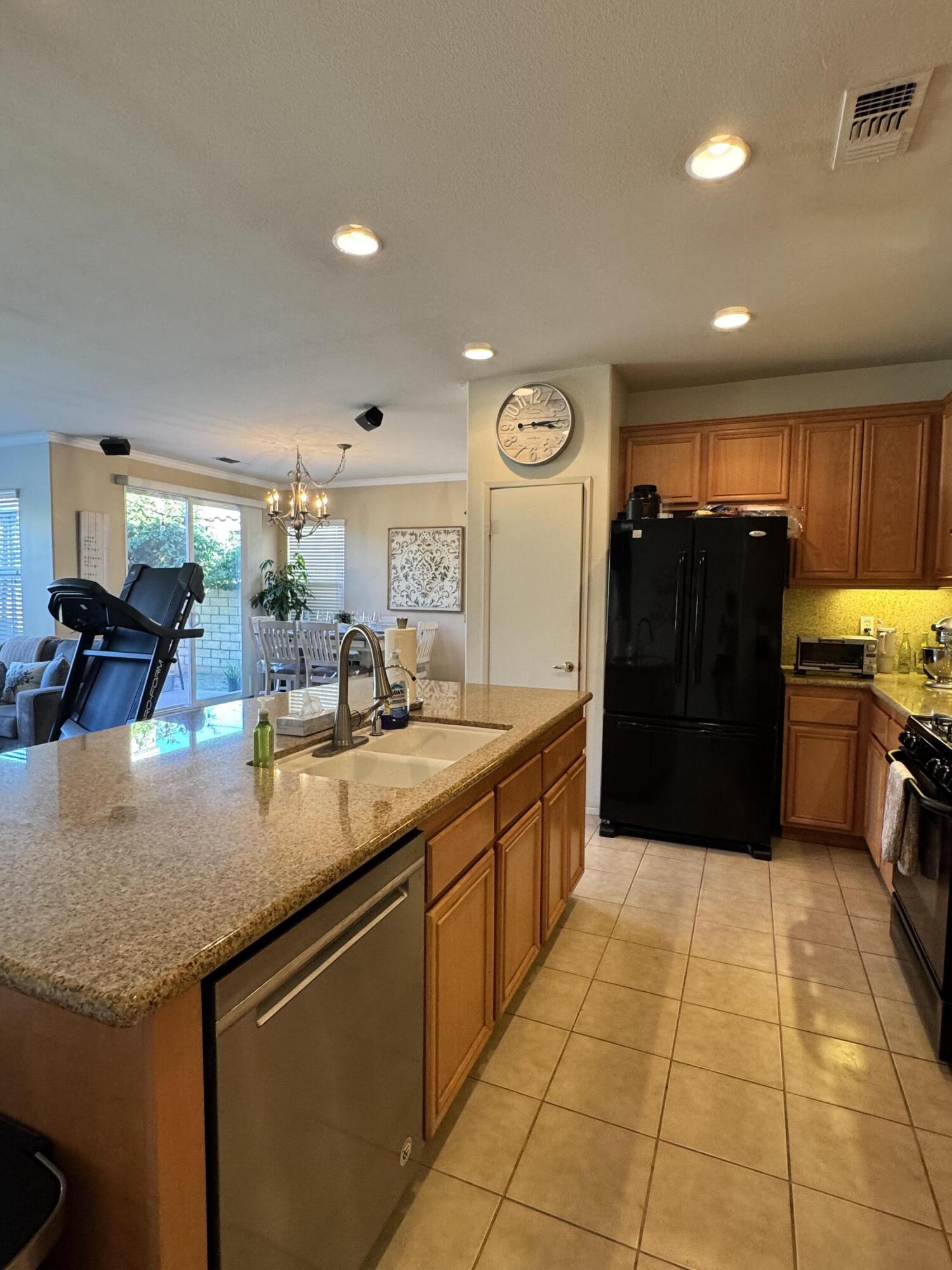 82774 Matthau Drive Indio, CA 92201 - Photo 32 of 44 a kitchen with stainless steel appliances granite countertop a refrigerator and a sink