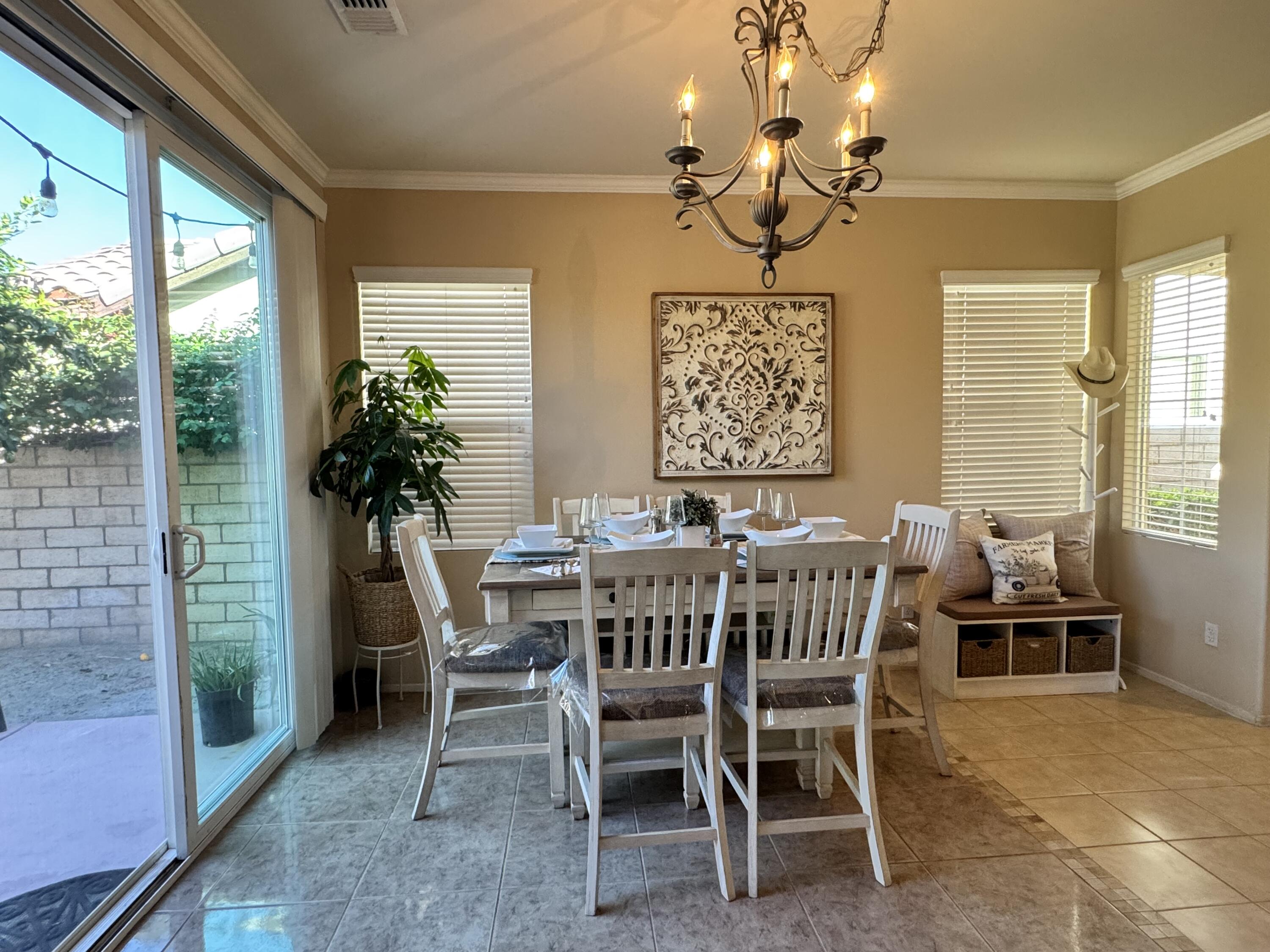 82774 Matthau Drive Indio, CA 92201 - Photo 38 of 44 a view of a dining room with furniture window and outside view