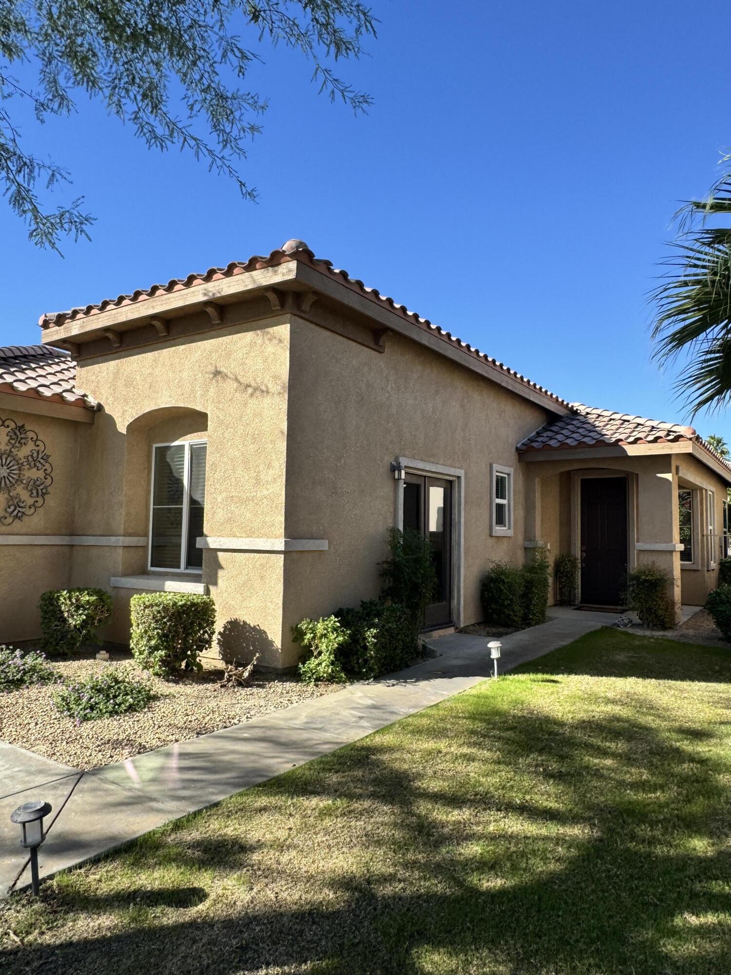 82774 Matthau Drive Indio, CA 92201 - Photo 42 of 44 a front view of a house with a yard
