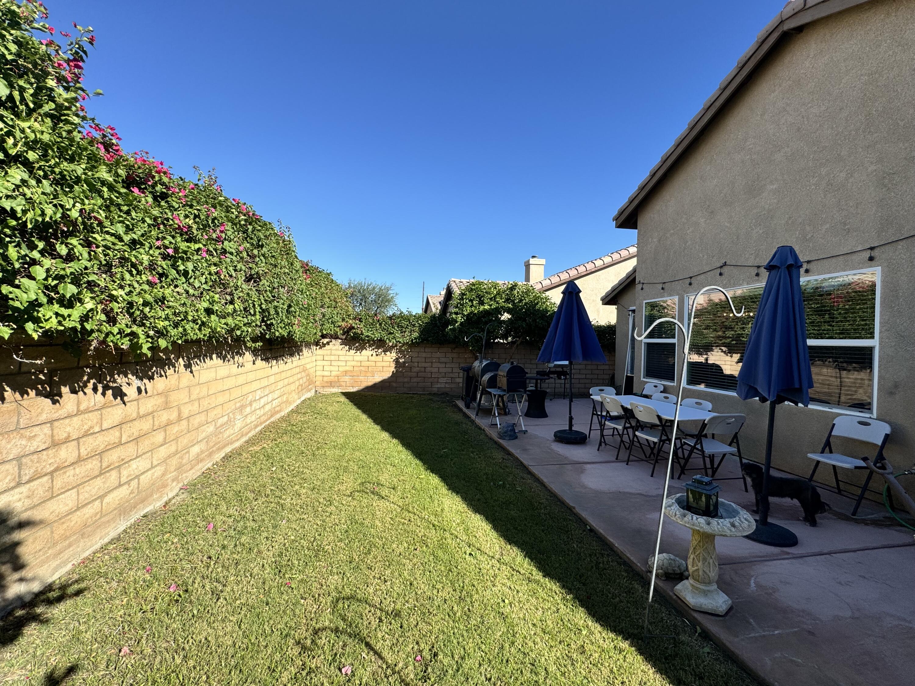 82774 Matthau Drive Indio, CA 92201 - Photo 9 of 44 a view of a backyard with sitting area