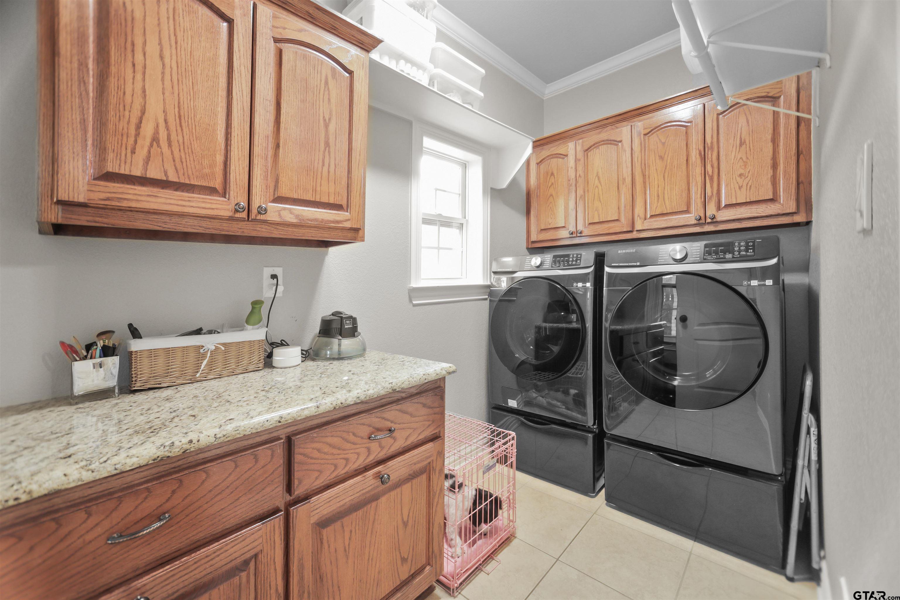 11931 State Highway 64 Tyler, TX 75704 - Photo 28 of 44 a utility room with granite countertop a sink a washer and dryer next to a window