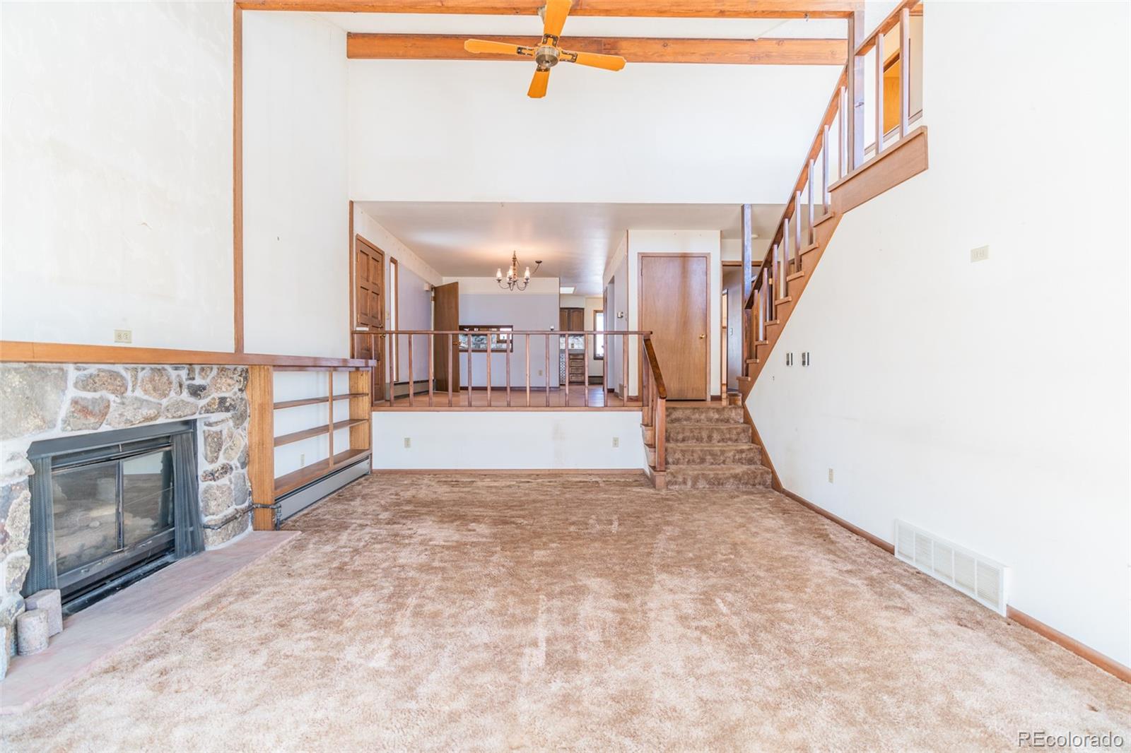 1189 Aspen Drive Evergreen, CO 80439 - Photo 12 of 37 a view of a livingroom with wooden floor and a fireplace