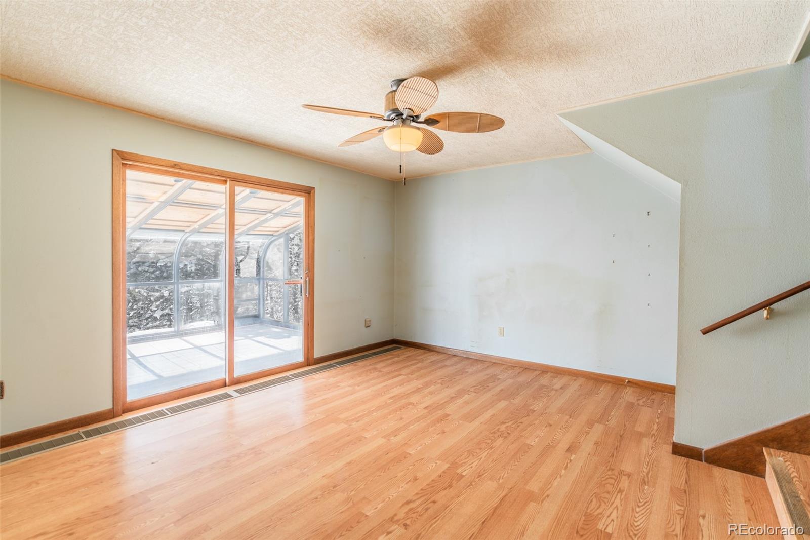 1189 Aspen Drive Evergreen, CO 80439 - Photo 16 of 37 an empty room with windows and fan