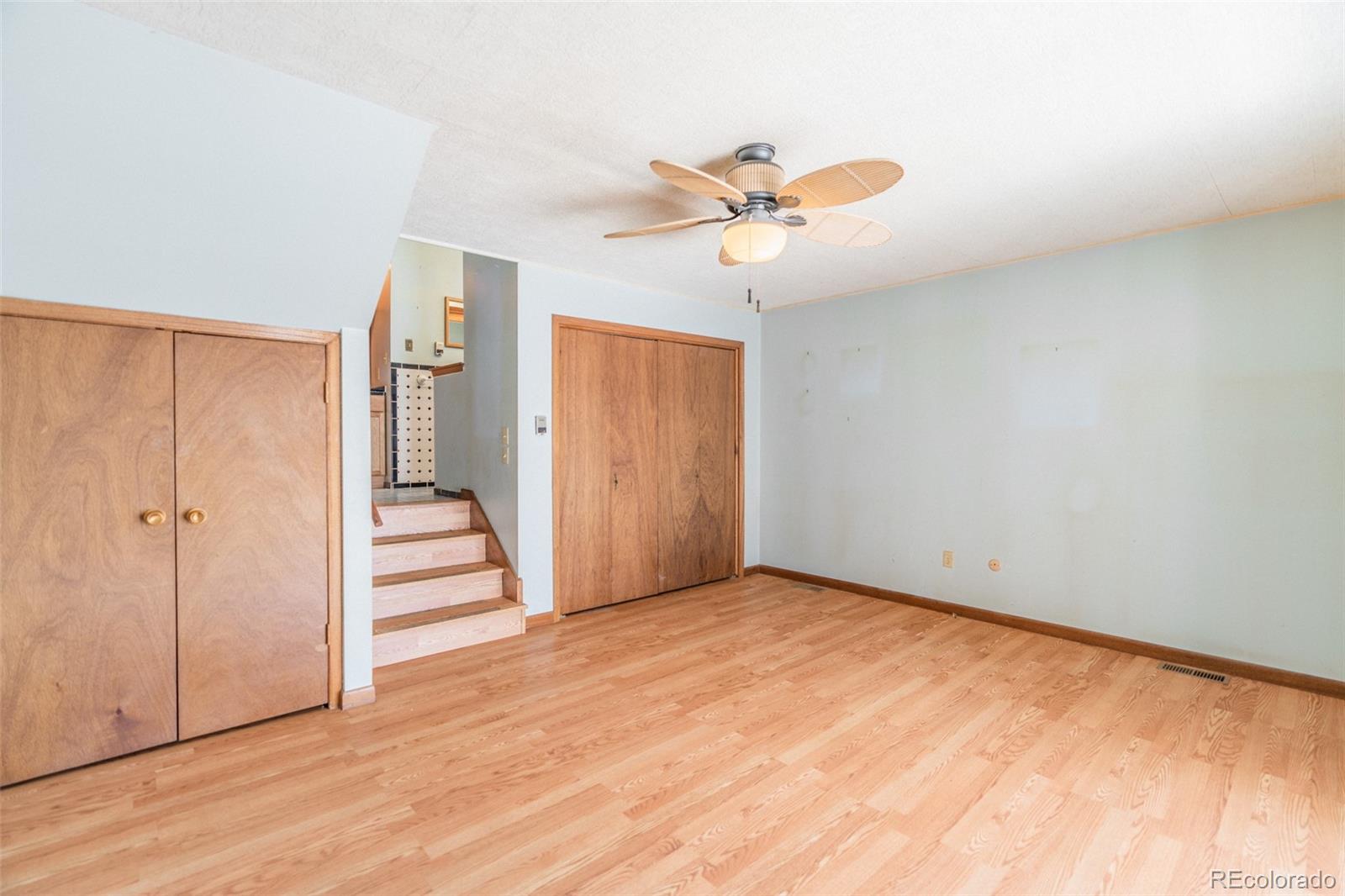1189 Aspen Drive Evergreen, CO 80439 - Photo 17 of 37 a view of a room with wooden floor and ceiling fan