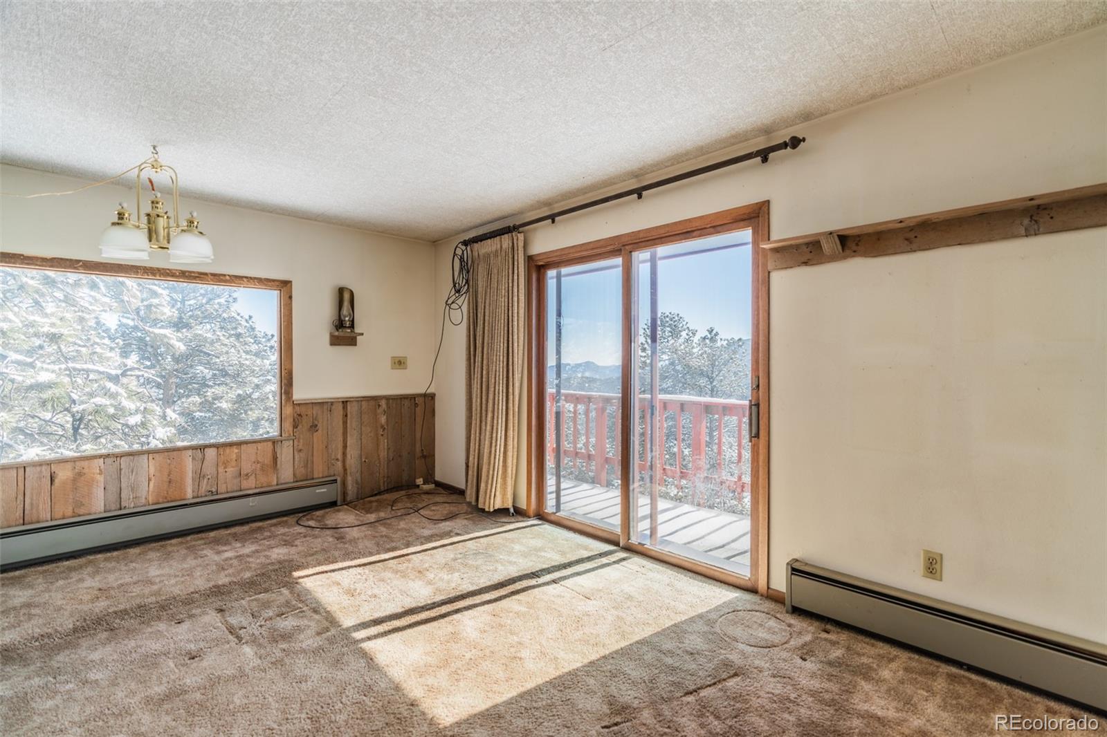 1189 Aspen Drive Evergreen, CO 80439 - Photo 19 of 37 a view of an empty room with wooden floor and a window